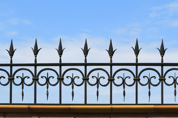 Metal forged fence on the background of sky
