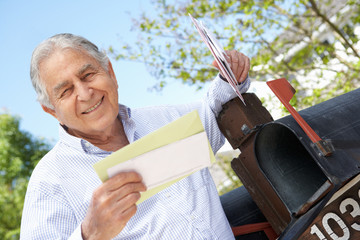 Senior Hispanic Man Checking Mailbox