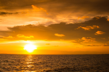 Naklejka na ściany i meble Beautiful sunset over the sea, orange color filtered effect