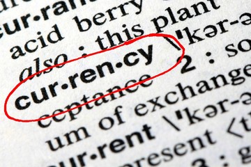 Fototapeta premium Closeup of the word currency in the English dictionary
