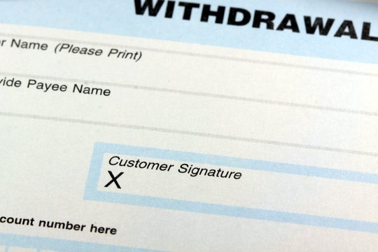 Withdrawal slip from bank checking or savings account - Finance and accounting concept