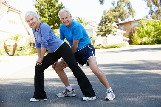 Elderly Man And Younger Woman Jogging