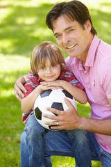 Father and son with football