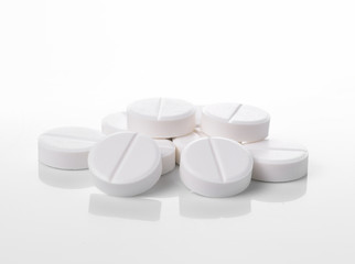 white pills on white background