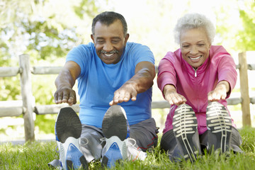 Senior African American Couple Exercising In Park - Powered by Adobe