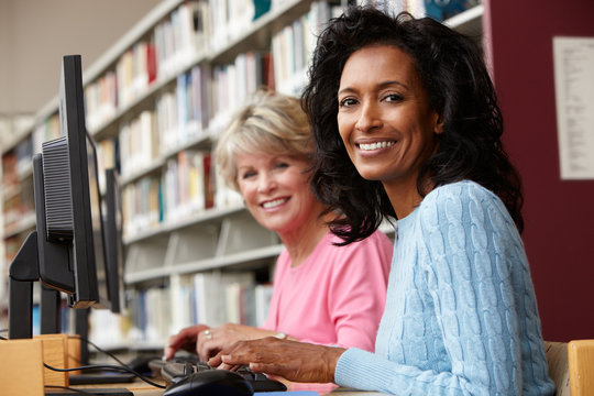 Women Working On Computers In Library