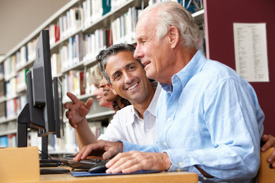 Students working on computers in library