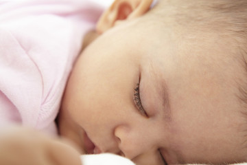 Close Up Of Sleeping Baby Girl At Home
