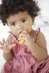 Young Girl Eating Carrot Stick