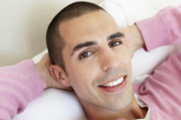 Young Man Relaxing On Bed