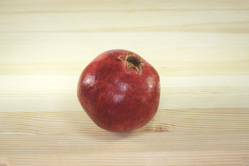 Fototapeta na wymiar Healthy lifestyle - Ripe juicy pomegranate lying on table top