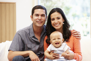 Obraz premium Hispanic couple at home with baby