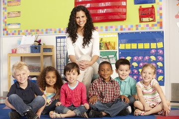 Group Of Elementary Age Schoolchildren In Class With Teacher