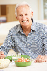 Senior man eating meal