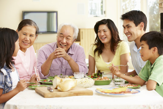 Asian family sharing meal at home - Powered by Adobe