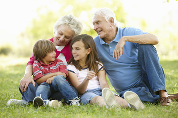 Senior couple and grandchildren in park