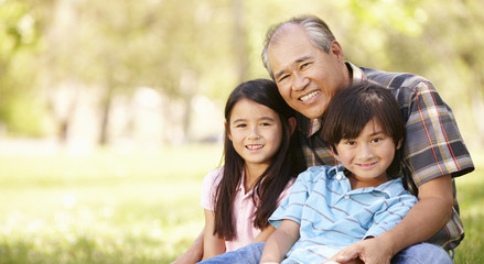 Fototapeta na wymiar Portrait Asian grandfather and grandchildren in park