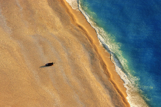 Lonely boat on a beach with aerial view.