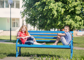 Fototapeta na wymiar two girls on bench in park