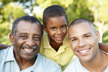 African American Grandfather, Father And Son Relaxing In Park - Powered by Adobe