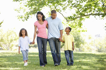 Fototapeta premium Young African American Family Enjoying Walk In Park