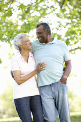 Romantic Senior African American Couple Walking In Park