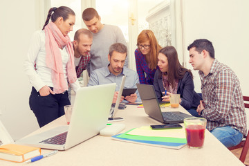 Young group of people discussing business plans.