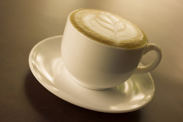 Cup of art latte or cappuccino coffee.