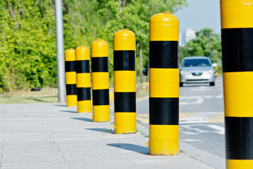 Yellow and black road safety studs with selected focus in a sunny day