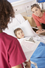 Nurse in hospital with sick boy and mother