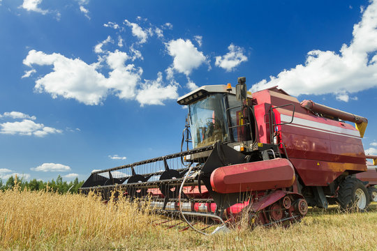 Combine harvester at the edge of grain field during harvest time