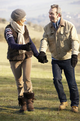 Mature couple on country walk in winter