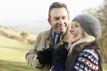 Mature couple on country walk in winter