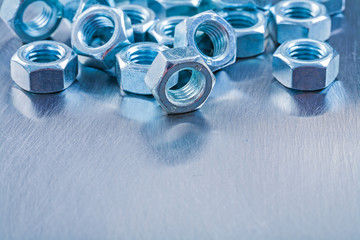 Big set of stainless screw nuts on metallic background construct