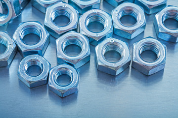 Close-up view of screw nuts on metallic background construction 