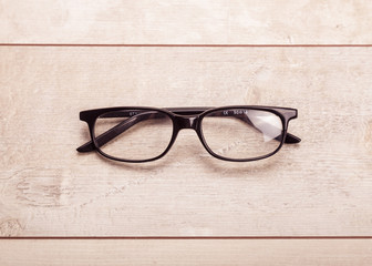 black glasses on wood  background