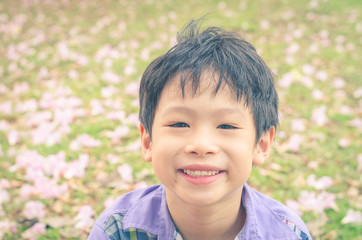 Asian boy smiling in garden,vintage filter effect