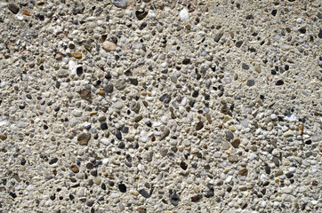 Plaster with pebbles on wall closeup