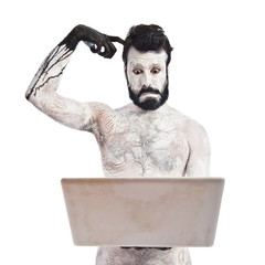 Painted man with laptop