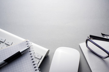 Keyboard, Mouse and Office Supplies on Grey Desk