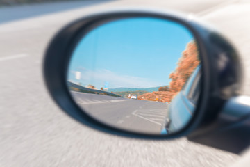 Colors of Tuscany countryside as seen from car mirror