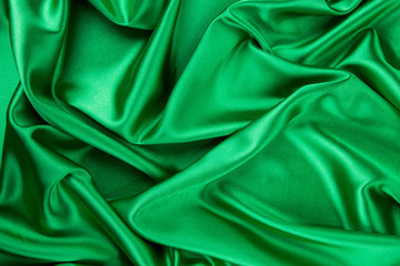 Green silk cloth with some soft folds.