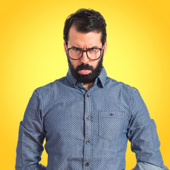 Fototapeta premium Sad hipster man over isolated white background