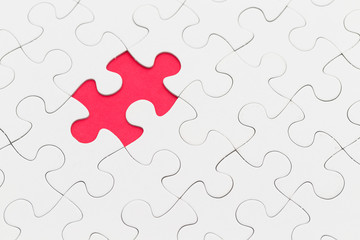 Fototapeta premium Puzzle with missing piece over red background