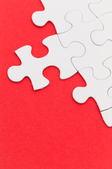 Plain white jigsaw puzzle on Red background
