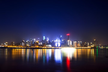 illuminated skyline of chongqing at riverbank