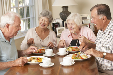 Fototapeta na wymiar Group Of Senior Couples Enjoying Meal Together