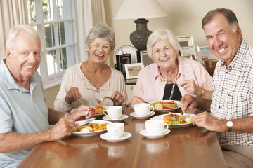 Group Of Senior Couples Enjoying Meal Together