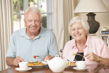 Senior Couple Enjoying Meal Together At Home
