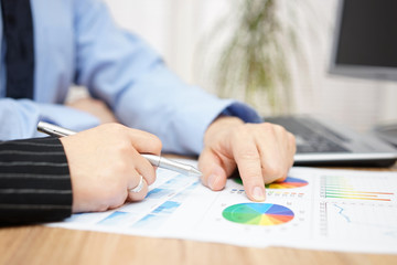 businessman and businesswoman discussing about company report in